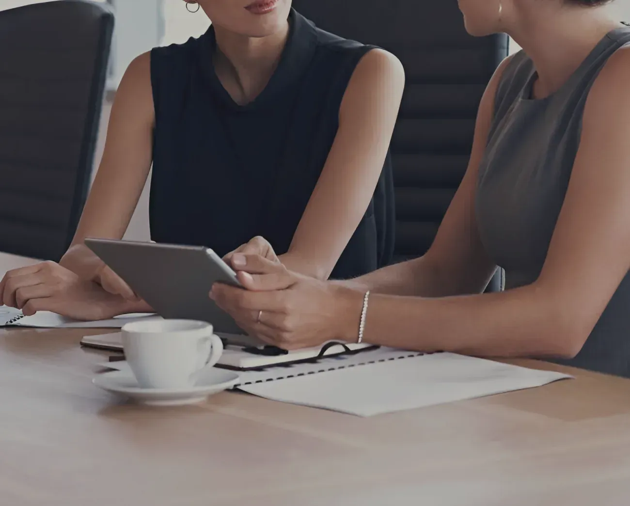 Two business leaders review financial performance data during a management reporting meeting.